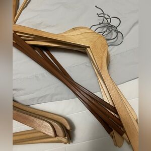 Seventeen good quality wooden hangers, half with grip bar